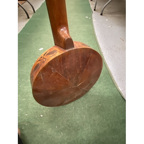 24 - A VINTAGE WOODEN BANJO WITH CARVING TO THE SIDES