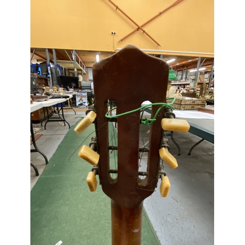 24 - A VINTAGE WOODEN BANJO WITH CARVING TO THE SIDES