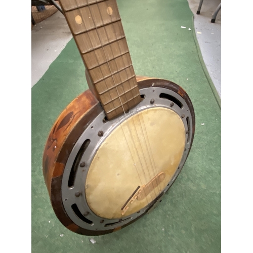 24 - A VINTAGE WOODEN BANJO WITH CARVING TO THE SIDES