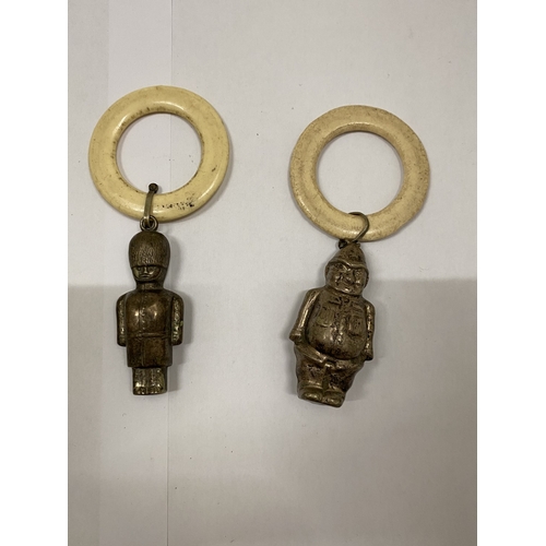 40 - THREE VINTAGE WHITE METAL RATTLES, AN ACORN, POLICEMAN AND SOLDIER