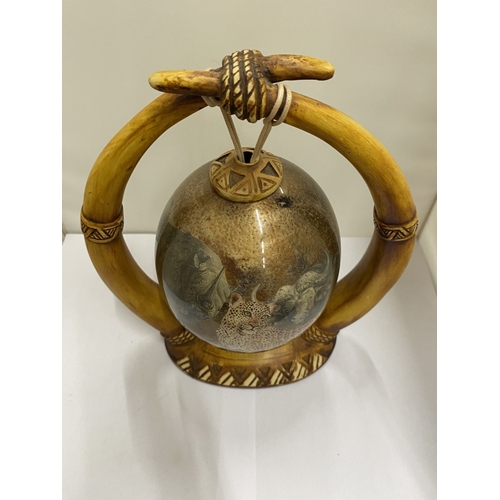47 - A HAND PAINTED OSTRICH EGG WITH A LION PICTURE ON A HORN STAND