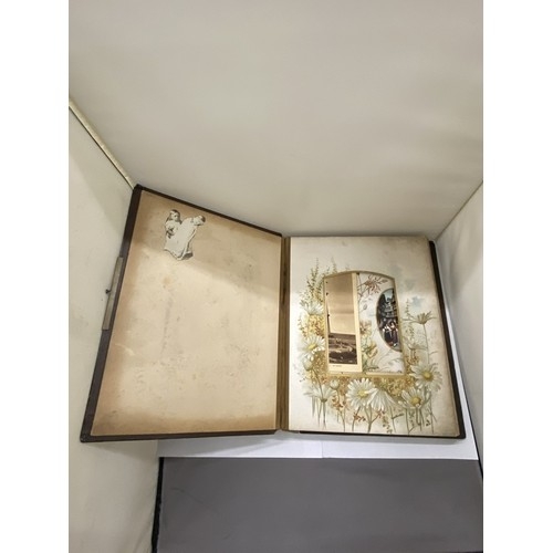 23 - A LEATHER BOUND VICTORIAN PHOTO ALBUM, CONTAINING PHOTOS AND POSTCARDS