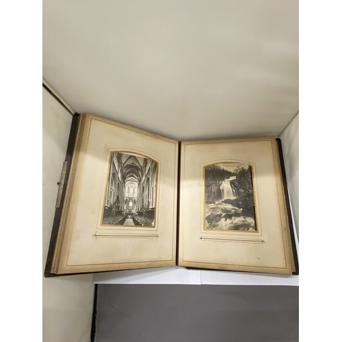 23 - A LEATHER BOUND VICTORIAN PHOTO ALBUM, CONTAINING PHOTOS AND POSTCARDS
