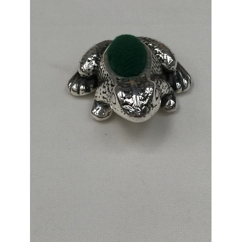 34 - A SILVER FROG PIN CUSION
