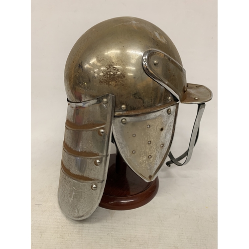 4 - A REPLICA CIVIL WAR LOBSTER POT RIDING HELMET ON A WOODEN STAND