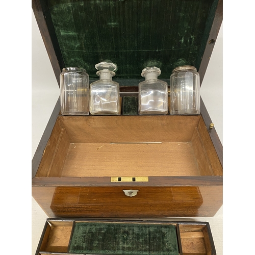 32 - A ROSEWOOD VANITY BOX  WITH CONTENTS WITH INLAID MOTHER OF PEARL AND A SECRET DRAWER