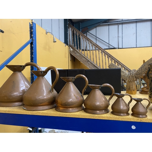 48 - A COLLECTION OF SIX BRASS AND COPPER GRADUATED MEASURING JUGS
