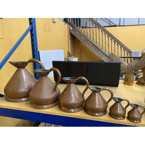 48 - A COLLECTION OF SIX BRASS AND COPPER GRADUATED MEASURING JUGS