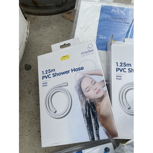 AN ASSORTMENT OF NEW AND PACKAGED SHOWER HEADS AND SHOWER HOSES