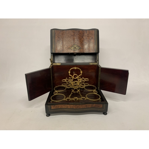 9 - A CONTINENTAL MAHOGANY LIQUEUR CABINET WITH INNER FITTINGS, A BURR WALNUT VENEER AND BUN FEET, HEIGH... 