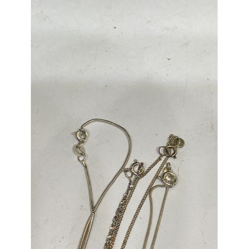 709 - FOUR SILVER NECKLACES WITH PENDANTS