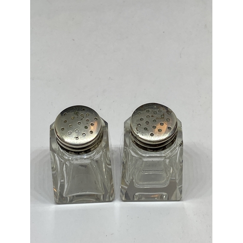 712 - A PAIR OF SILVER TOP CRUETS