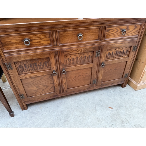 2536 - A JAYCEE OAK DRESSER WITH RACK ENCLOSING TWO GLAZED AND LEADED DOORS, 54