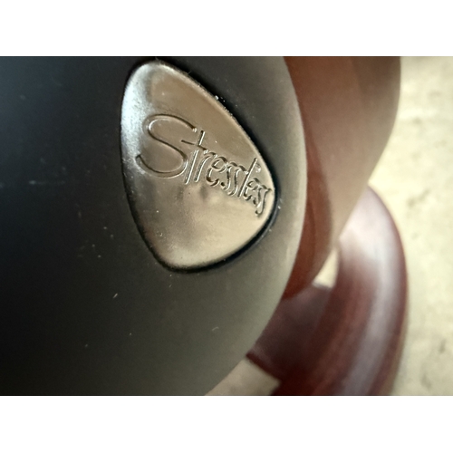 2540 - A STRESSLESS EKORNES LEATHER SWIVEL RECLINER CHAIR AND STOOL