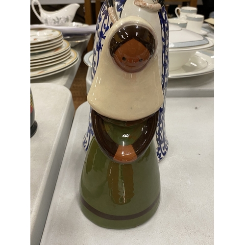 143 - A BLUE AND WHITE CERAMIC BELL GIRL WITH A YELLOW HAT TOGETHER WITH A JIE KERAMIK GANTOFTA STYLE CERA... 
