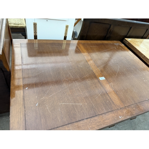 2633 - A MID 20TH CENTURY OAK TWIN PEDESTAL DRAW LEAF DINING TABLE