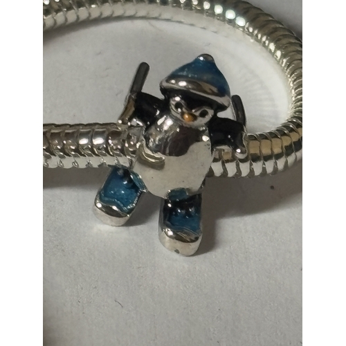 610 - A MARKED 925 CHARM BRACLET WITH CHRISTMAS PENGUIN CHARM IN A PRESENTATION BOX