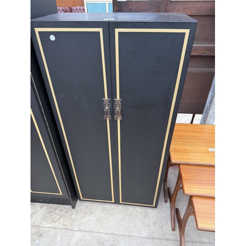2759 - A BLACK AND GOLD PAINTED TWO DOOR WARDROBE AND MATCHING SMALLER WARDROBE