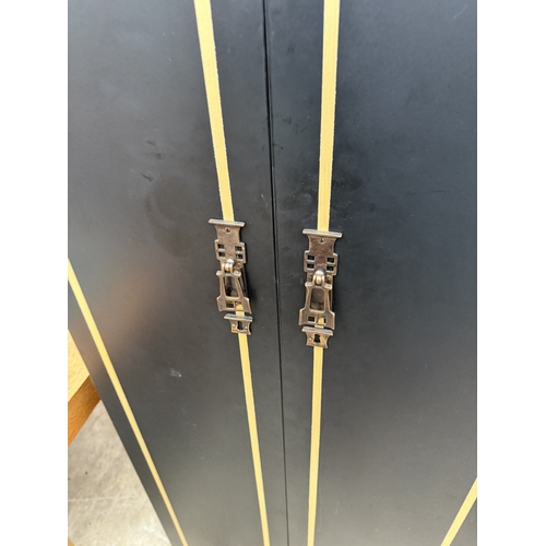 2759 - A BLACK AND GOLD PAINTED TWO DOOR WARDROBE AND MATCHING SMALLER WARDROBE