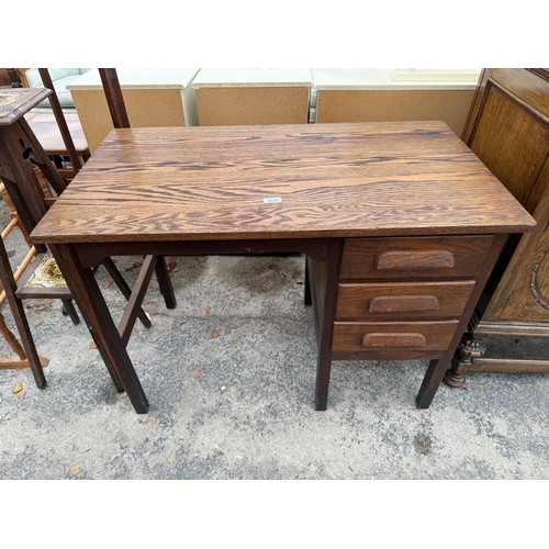 2745 - A MID 20TH CENTURY OAK SINGLE PEDESTAL DESK ENCLOSING THREE DRAWERS, 39