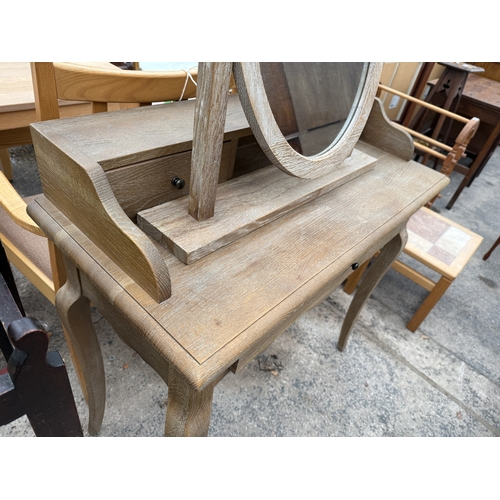 2749 - A LIMED OAK DRESSING TABLE WITH SWING FRAME MIRROR, 35