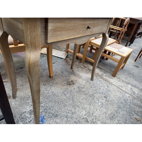 2749 - A LIMED OAK DRESSING TABLE WITH SWING FRAME MIRROR, 35