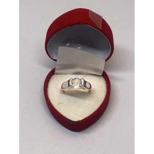 641 - A MARKED 925 CLEAR STONE SOLITAIRE RING IN A HEART SHAPED PRESENTATION BOX