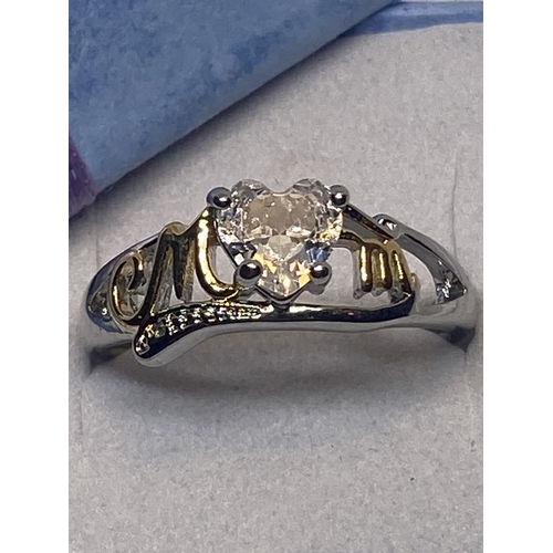 695 - A MARKED 925 MUM RING WITH HEART SHAPED CENTRE CLEARSTONE IN A PRESENTATION BOX