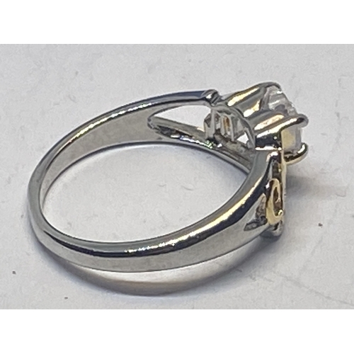 695 - A MARKED 925 MUM RING WITH HEART SHAPED CENTRE CLEARSTONE IN A PRESENTATION BOX