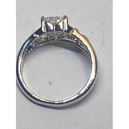 695 - A MARKED 925 MUM RING WITH HEART SHAPED CENTRE CLEARSTONE IN A PRESENTATION BOX