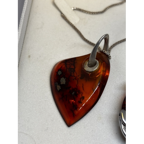 527 - FOUR SILVER AND AMBER ITEMS TO INCLUDE TWO BRACELETS, A PAIR OF EARRINGS AND A PENDANT ON A SILVER C... 