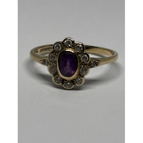 529 - A MARKED 9 CARAT GOLD RING WITH CENTRE AMETHYST SURROUNDED BY TEN DIAMONDS WITH DIAMOND CHIPS TO THE... 