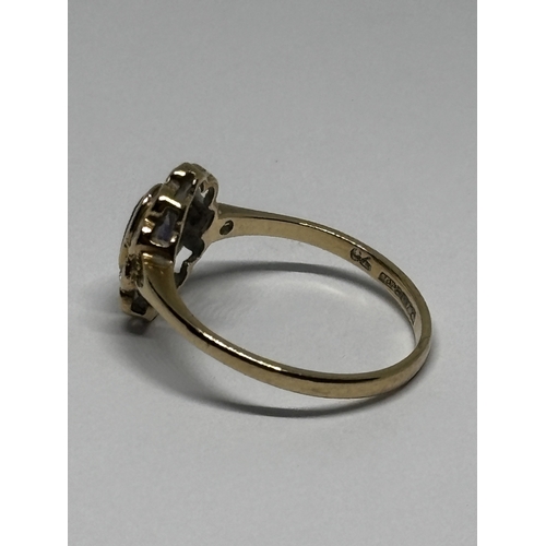 529 - A MARKED 9 CARAT GOLD RING WITH CENTRE AMETHYST SURROUNDED BY TEN DIAMONDS WITH DIAMOND CHIPS TO THE... 