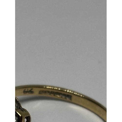 529 - A MARKED 9 CARAT GOLD RING WITH CENTRE AMETHYST SURROUNDED BY TEN DIAMONDS WITH DIAMOND CHIPS TO THE... 