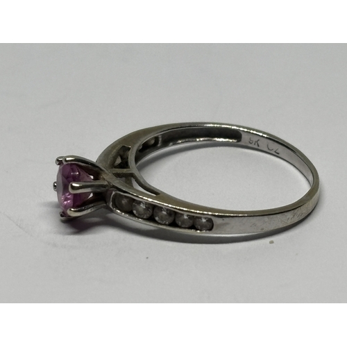 545 - A MARKED 9 CARAT WHITE GOLD RING WITH PINK STONE AND CUBIC ZIRCONIAS TO THE SHOULDERS SIZE I/J GROSS... 