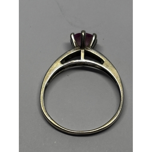 545 - A MARKED 9 CARAT WHITE GOLD RING WITH PINK STONE AND CUBIC ZIRCONIAS TO THE SHOULDERS SIZE I/J GROSS... 
