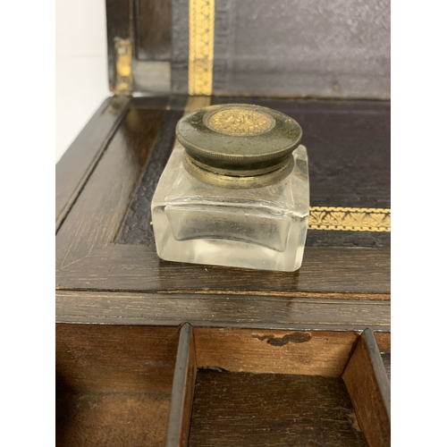 14 - A BURR WALNUT WRITING SLOPE WITH SECRET DRAWER AND BRASS BANDING