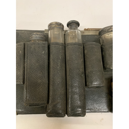 20 - A QUANTITY OF VANITY GLASS BOTTLES MOST WITH HALLMARKED SILVER LIDS, IN A HOLDER, PLUS  HALLMARKED S... 