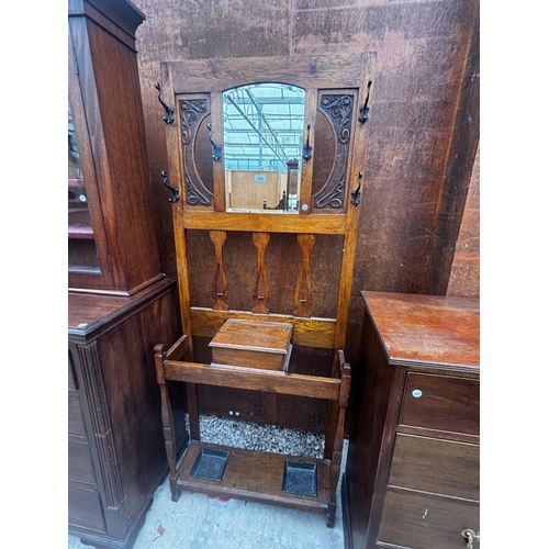2508 - AN ART NOUVEAU OAK HALL STAND WITH MIRRORED BACK, 30