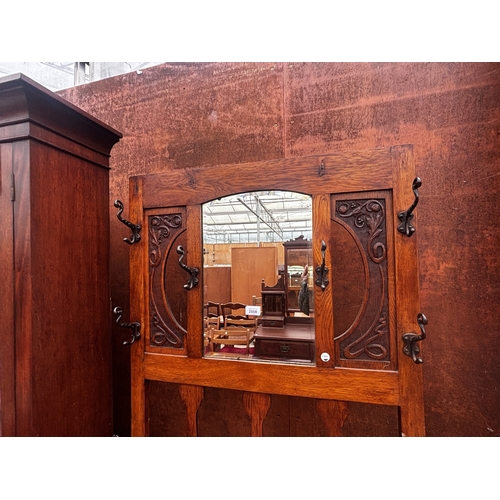 2508 - AN ART NOUVEAU OAK HALL STAND WITH MIRRORED BACK, 30