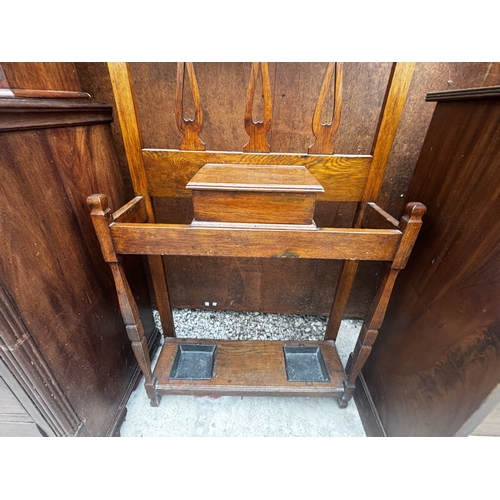 2508 - AN ART NOUVEAU OAK HALL STAND WITH MIRRORED BACK, 30