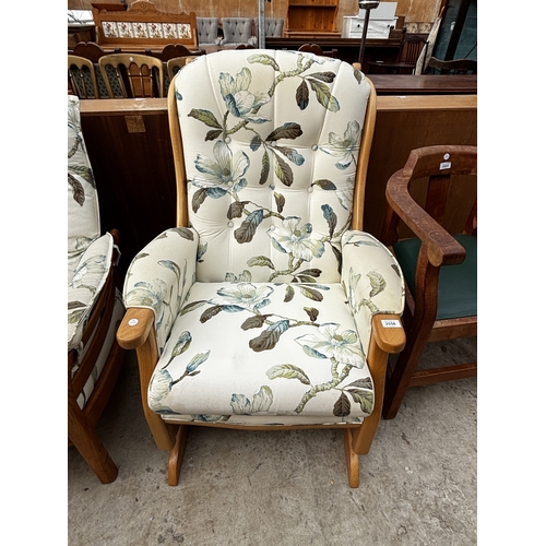 2556 - AN ERCOL THREE SEATER SETTEE, FIRESIDE CHAIR AND STOOL WITH SIMILAR UPHOLSTERED ROCKING CHAIR