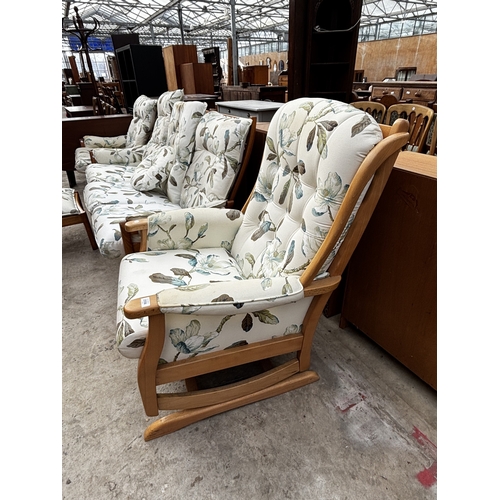 2556 - AN ERCOL THREE SEATER SETTEE, FIRESIDE CHAIR AND STOOL WITH SIMILAR UPHOLSTERED ROCKING CHAIR