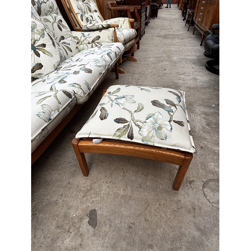 2556 - AN ERCOL THREE SEATER SETTEE, FIRESIDE CHAIR AND STOOL WITH SIMILAR UPHOLSTERED ROCKING CHAIR