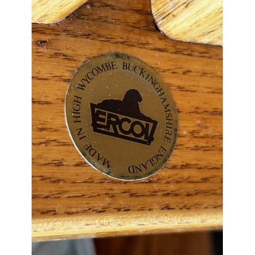 2556 - AN ERCOL THREE SEATER SETTEE, FIRESIDE CHAIR AND STOOL WITH SIMILAR UPHOLSTERED ROCKING CHAIR