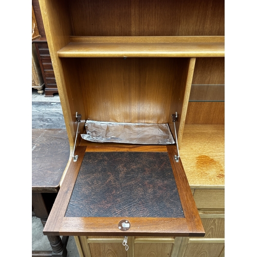 2589 - A NATHAN STYLE RETRO COCKTAIL SIDEBOARD ENCLOSING DROP DOWN SECTION, FOUR CUPBOARDS, THREE DRAWERS A... 