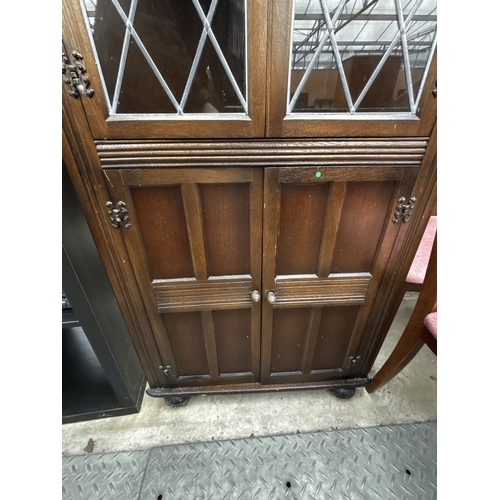 2596 - A PRIORY OAK CORNER CUPBOARD WITH GLAZED AND LEADED UPPER PORTION, 27