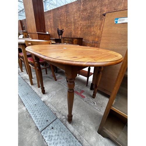 2603 - A PINE OVAL EXTENDING KITCHEN TABLE ON TURNED LEGS, 43