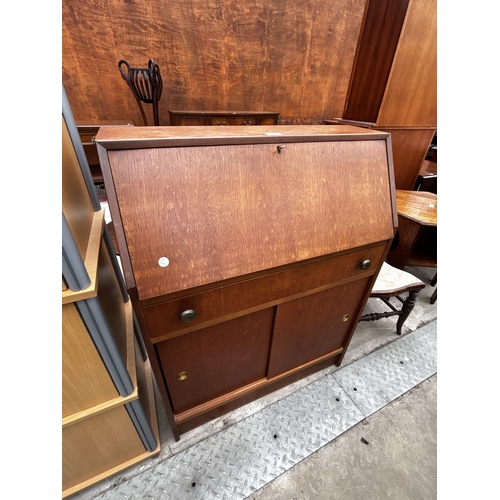2607 - A RETRO TEAK BUREAU WITH SLIDING DOORS TO BASE, 29.5