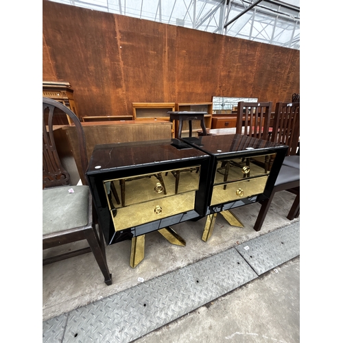 2612 - A PAIR OF BLACK GLASS BEDSIDE CHESTS EACH WITH TWO GOLD COLOURED DRAWERS AND MIRRORED LEGS